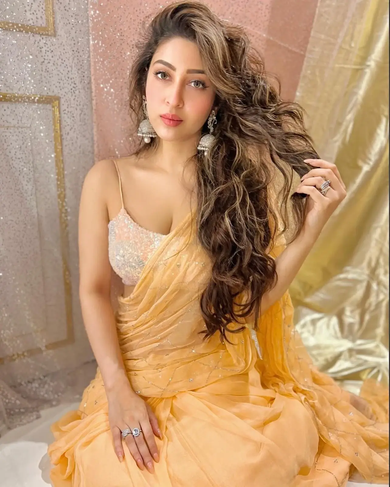 South Indian Girl Sonarika Bhadoria Long Hair Stills in Orange Saree